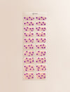 Nail Art Gel Nail Sticker strip with 20 gel nail stickers with a nail art pattern of purple flowers on a pink pastel base with tiny silver studs